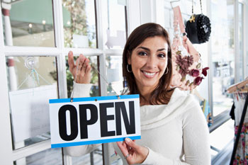 A customer shows business open signage