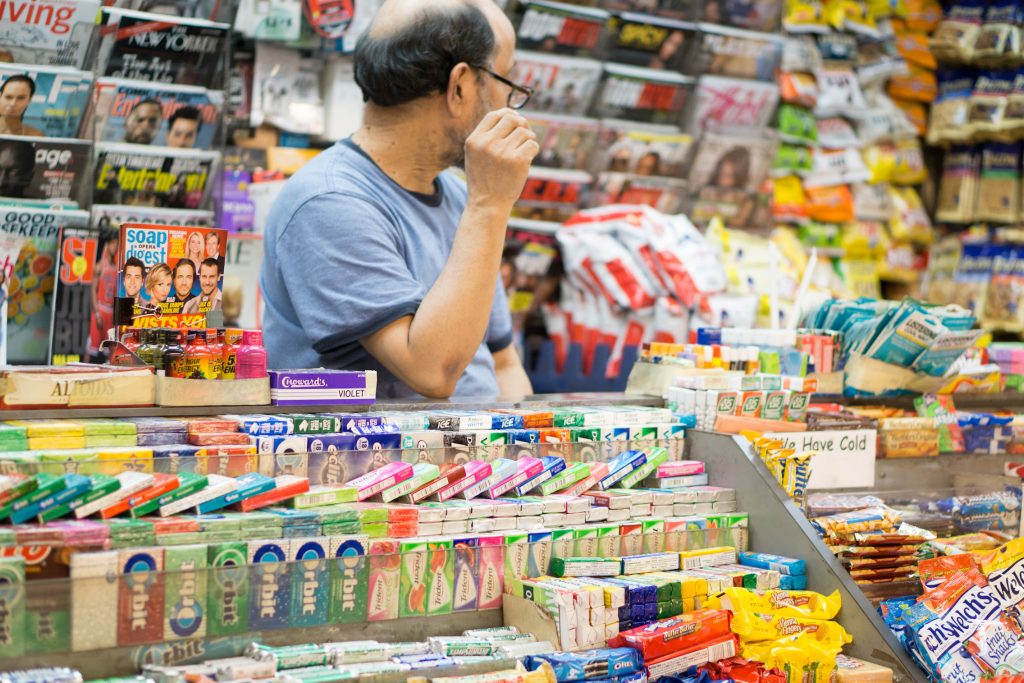 Convenience store owner with goods at the store