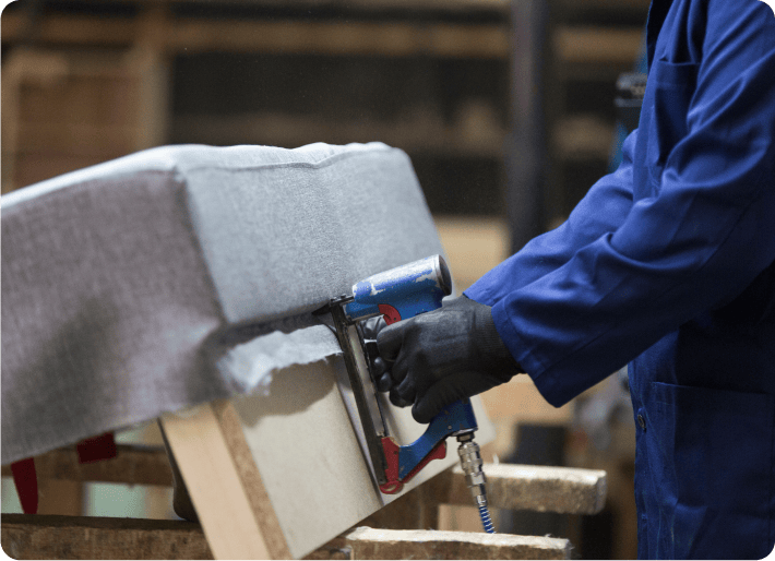 A person polishing a piece of furniture