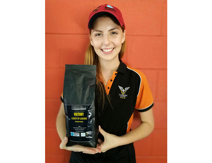 A woman holding a bag of coffee beans, ready to brew a fresh cup of aromatic coffee.