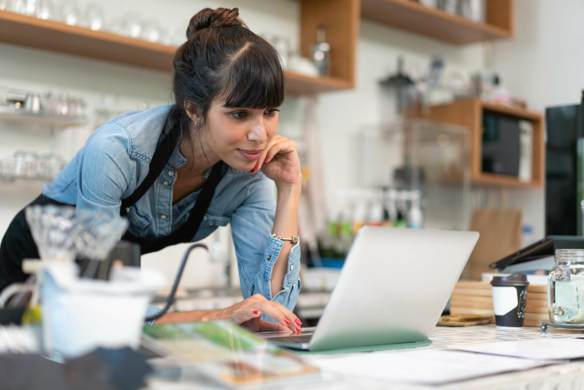 Female business owner checking online order from customer
