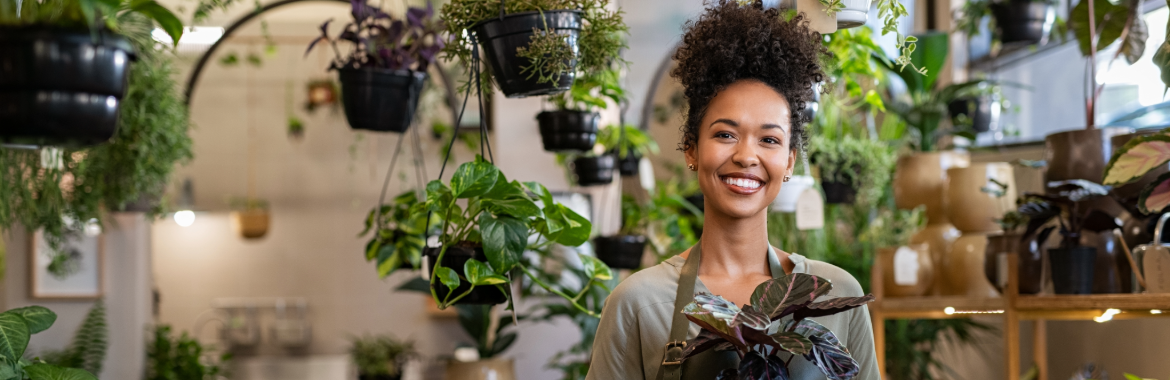 A happy business owner in her plant shop.