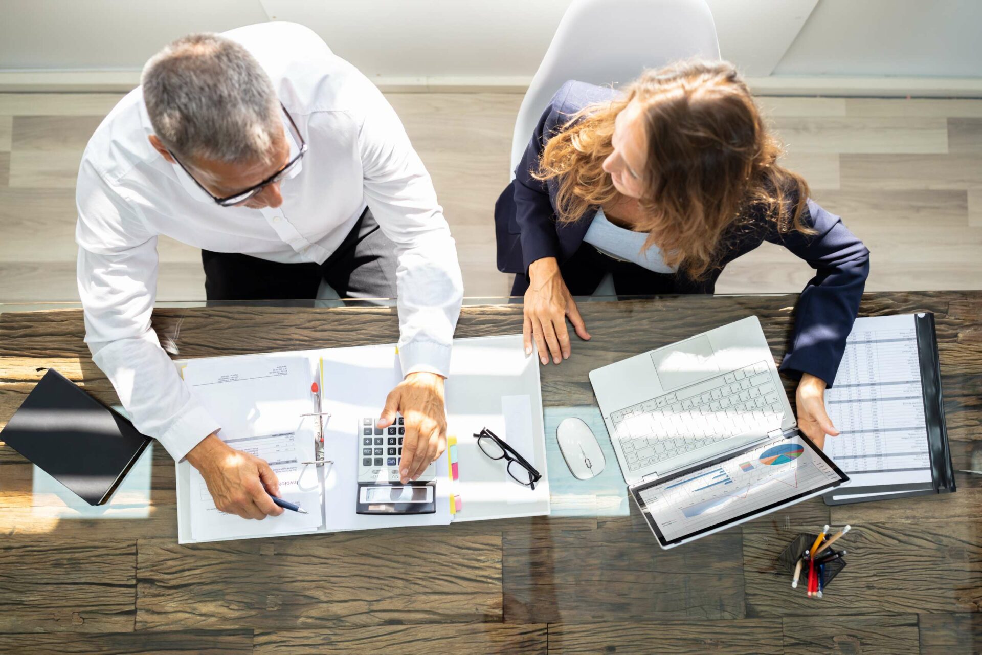 Consultants Using Laptop In Office