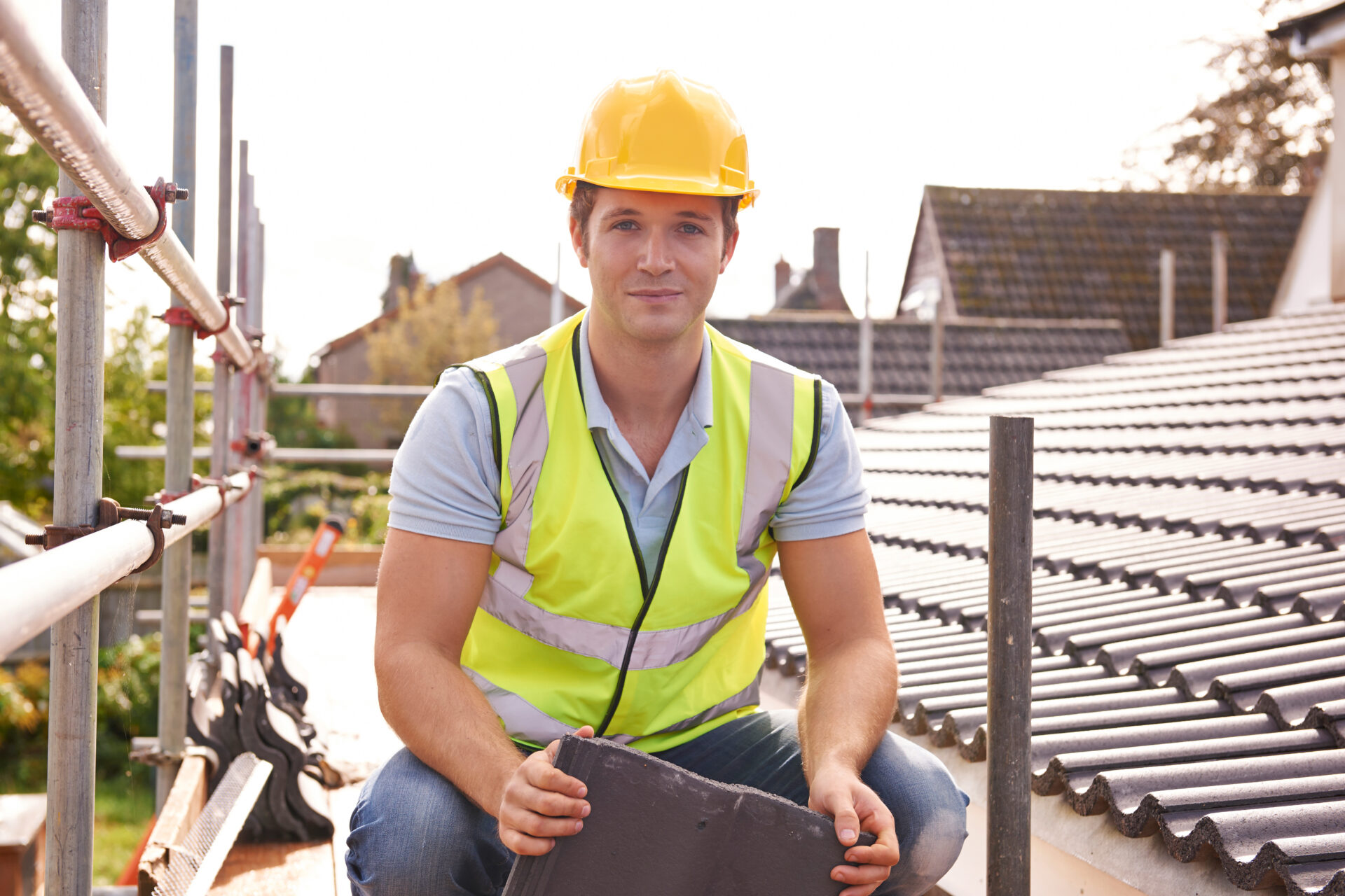 Building contractor working on roof of new building