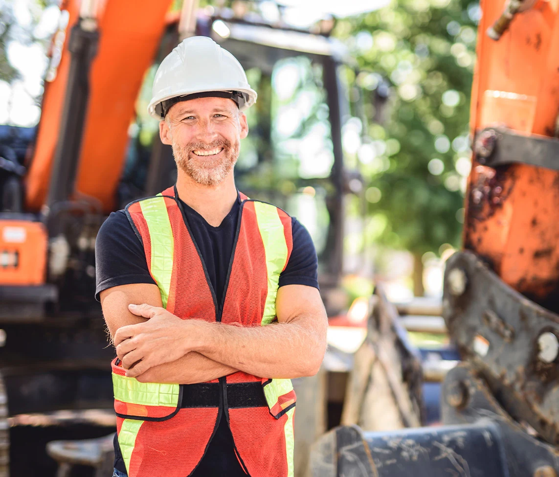 A plant equipment business owner with the equipment behind