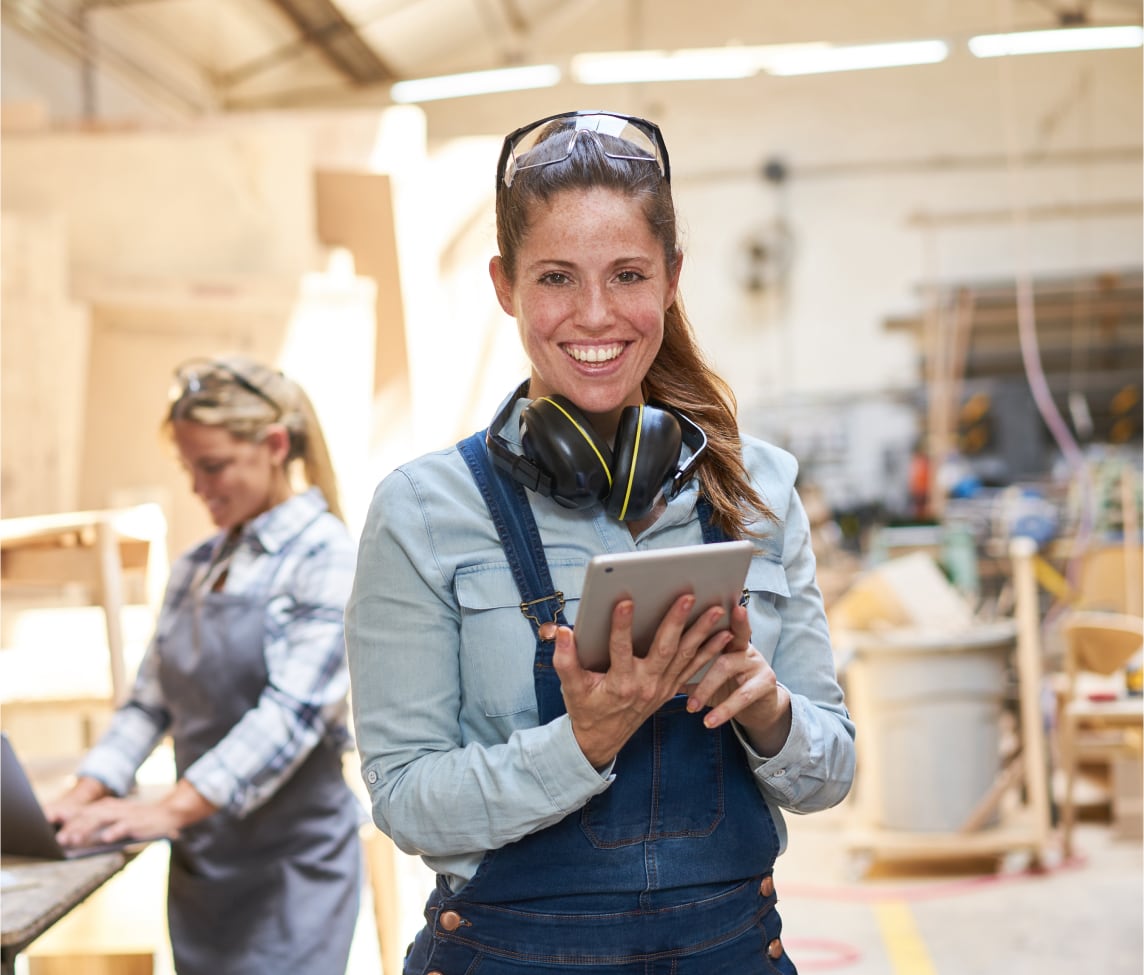 A tradeswoman working with a device