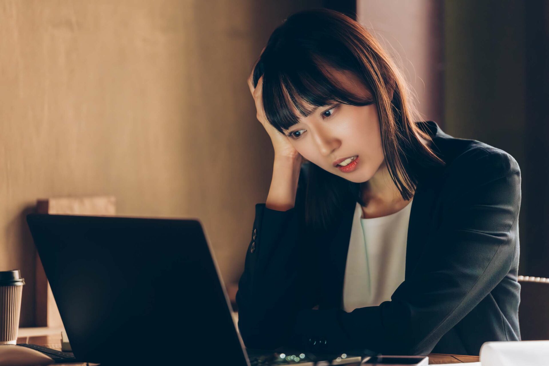 A businesswoman looking at laptop