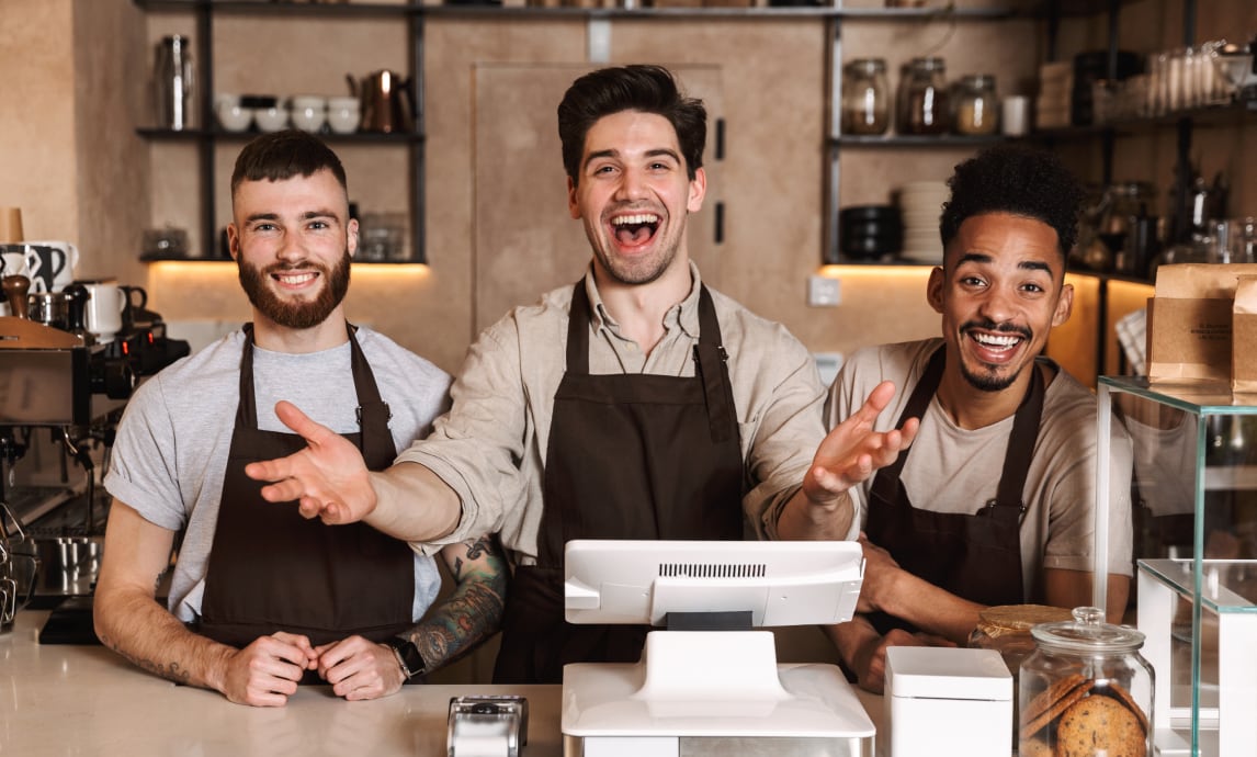 Baristas behind the counter, in a coffee shop