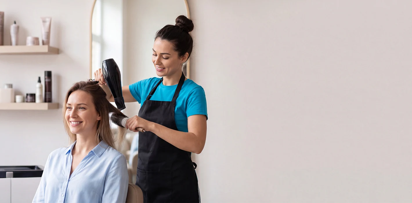 A beautician cutting a client's hair
