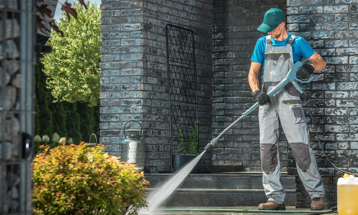 A pressure washer cleans  flooring with high pressure water jet