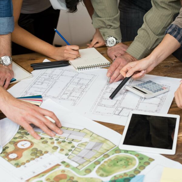Architect team discussing on blueprints