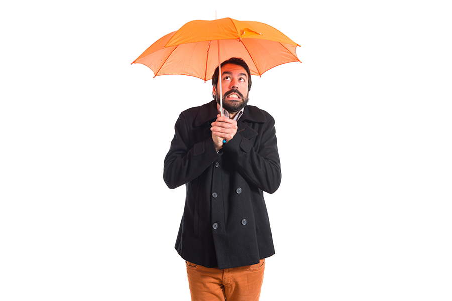 A business person under umbrella - insurance protection